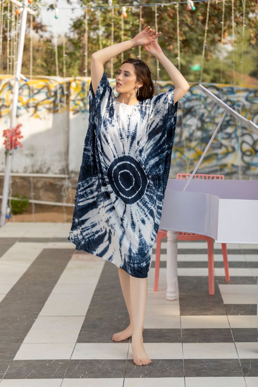 Woman in an indigo tie-dye kaftan outdoors